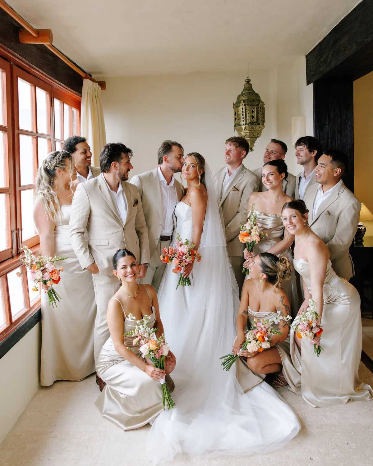 Wedding party portrait in the arched interior of Hotel Playa Fiesta Puerto Vallarta by Evgenia Kostiaeva